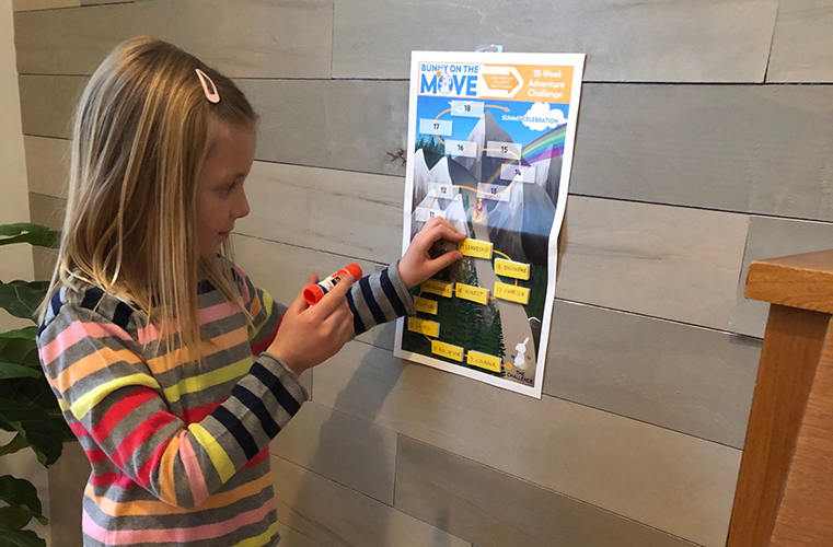 A little girl is playing with a game.